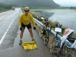 Frank folding up his raincoat